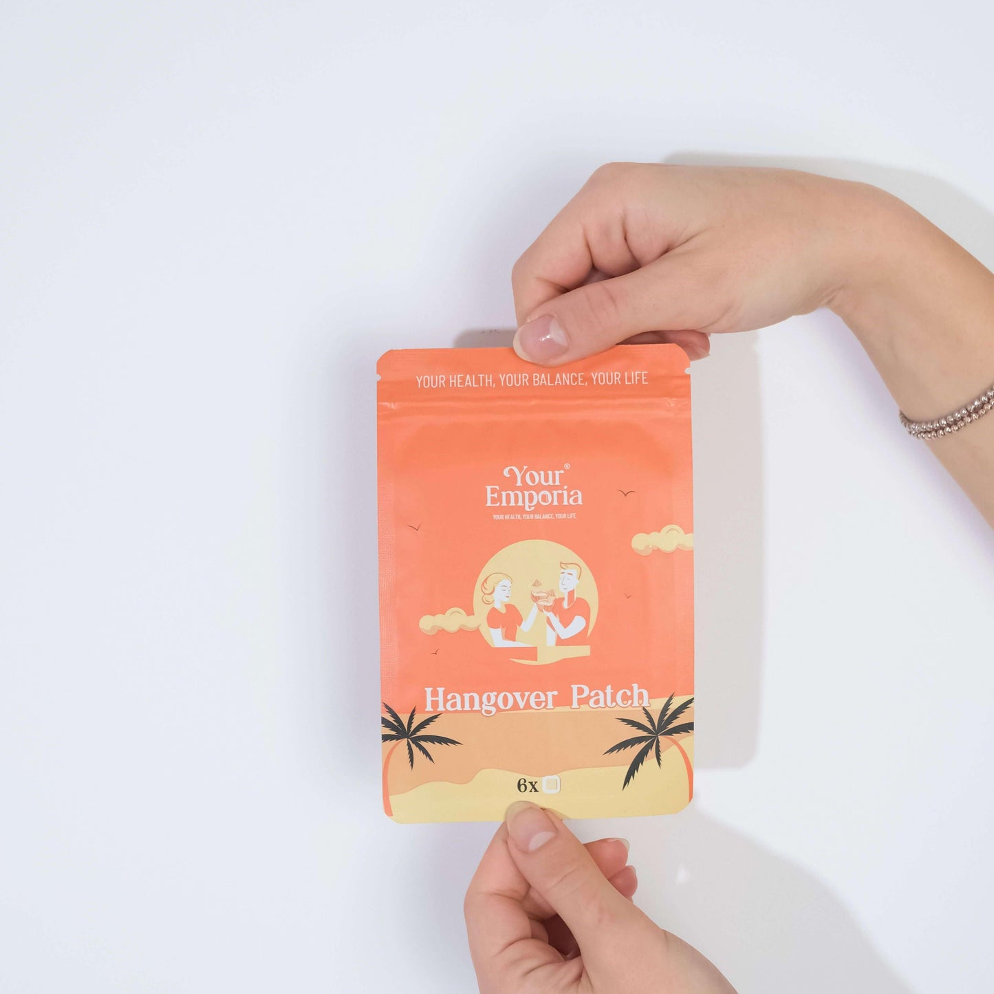 Person holding 'Your Emporia' Hangover Patch packaging with tropical design, promoting health and balance.