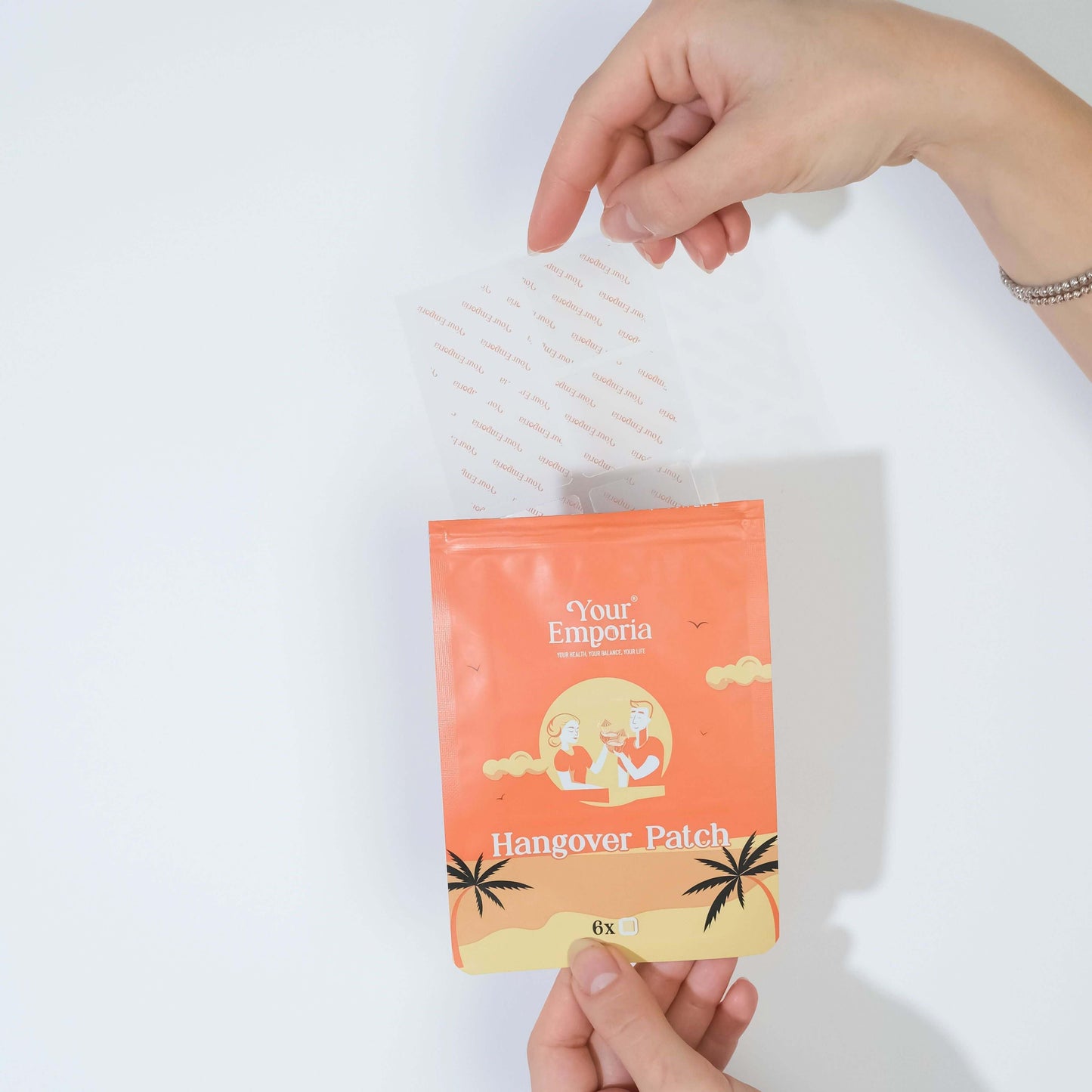 Woman holding a Hangover Patch package from 'Your' Emporia, showcasing its vibrant tropical design.